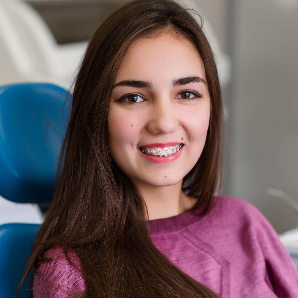 A smiling adult patient or side-view of a lingual appliance