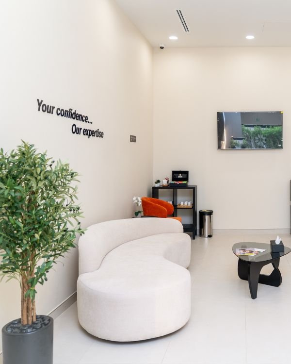 Modern dental clinic reception area at IB Clinic Dubai, showcasing clean interiors, warm lighting, and comfortable seating.