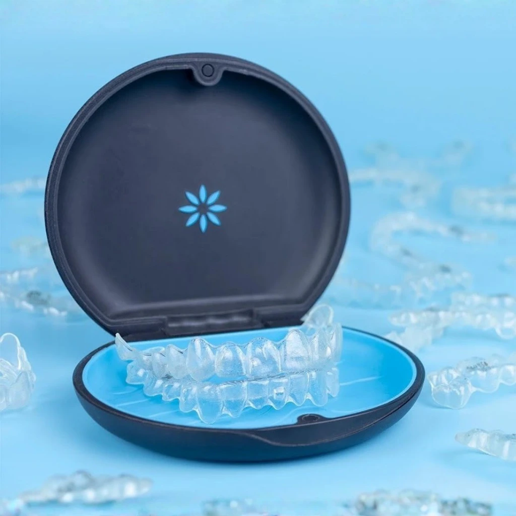Close-up image of Invisalign clear aligners placed inside a protective case, representing the convenience, hygiene, and advanced design offered at Invisible Braces Dental & Skin Clinic Dubai under Dr. Nikhil Sharma.