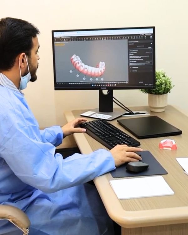Dr Nikhil Sharma orthodontic specialist planning digital braces treatment at Invisible Braces Dental & Skin Polyclinic Dubai