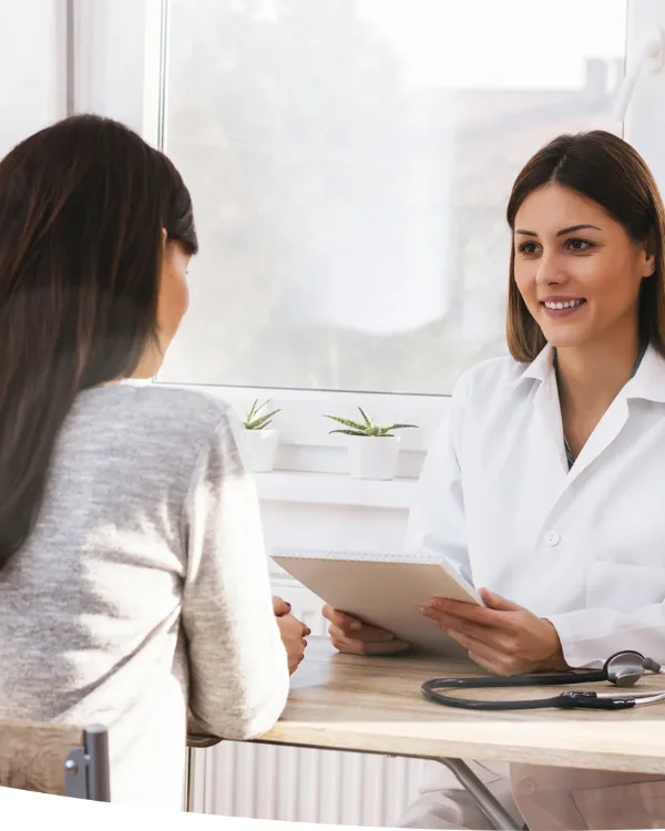 Orthodontist discussing Damon braces treatment plan with a patient during consultation.