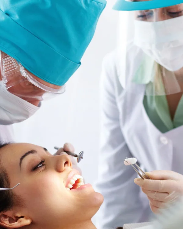 Dentist examining a patient with Damon braces during orthodontic treatment.